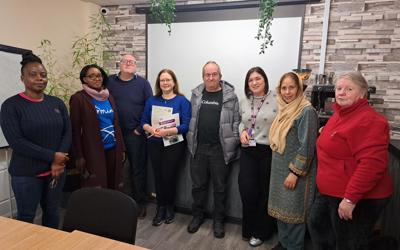 Group photo of customers and colleagues at Spotland Community Centre