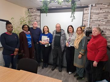 Group photo of customers and colleagues at Spotland Community Centre